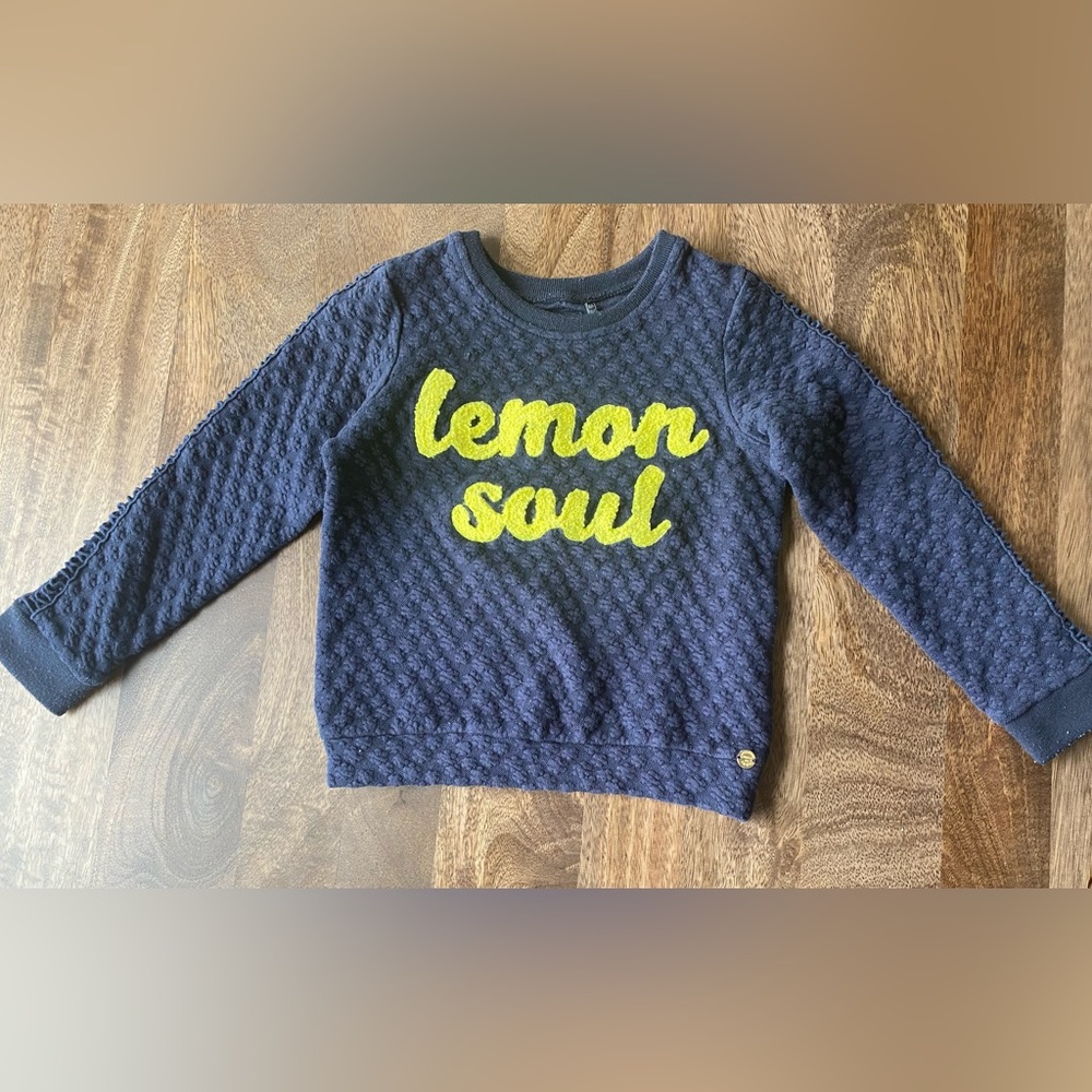 Navy blue textured sweatshirt with yellow lemon soul writing.
